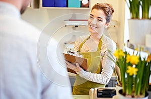 Florist woman and man making order at flower shop