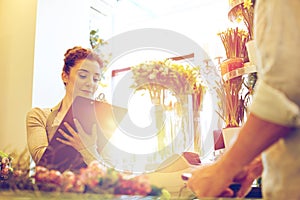 Florist woman and man making order at flower shop