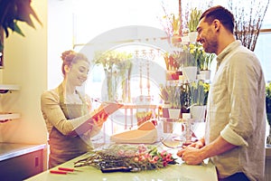 Florist woman and man making order at flower shop