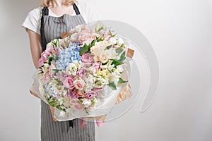 Florist at work. Make Serenity hydrangea rich bouquet. flowers in their hands