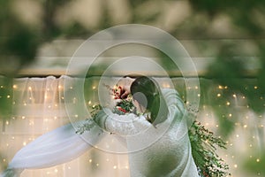 Florist worker woman decorates arch for ceremonial marriage