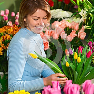 Florist in the workplace. Flower shop. Portrait of a smiling beautiful woman