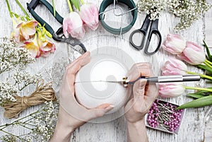 Florist workplace: woman making floral arrangements