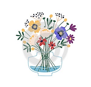 Floristic composition of beautiful garden and meadow flowers in glass vase. Elegant bouquet of wildflowers. Bunch of photo