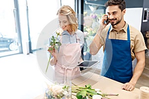 Florists working with digital devices