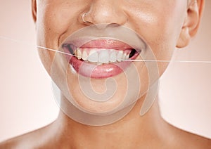 Floss, woman and smile with dental care, clean mouth and after brushing teeth against studio background. Oral health