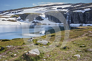 Flotane waterfall along the scenic Aurlandsfjellet route in Norway is a popular travel destination shown during a summer day