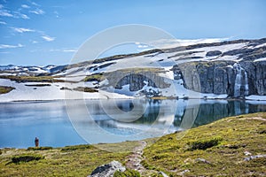 Flotane waterfall along the scenic Aurlandsfjellet route in Norway is a popular travel destination shown during a summer day