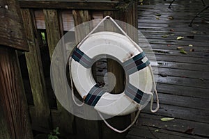 Flotation ring on dark wooden dock background