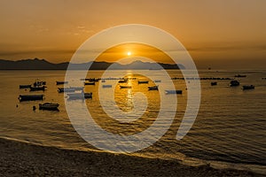 A flotilla of small boats moored at Aspra Sicily at sunset