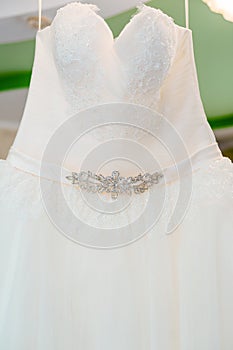 Flounces of delicate textile wedding dress hanging