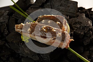 A flounder fillets on coals ready for cooking