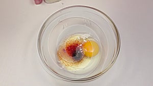 Flour add to bowl with egg and spices, slow motion