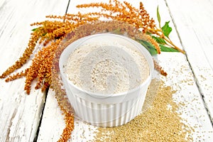 Flour amaranth in white bowl on board photo
