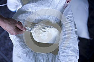 Flour baker in kitchen close up on female hand
