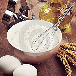 Flour and baking ingredients on the table. Vintage retro hipster