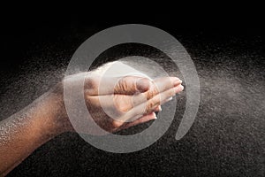 Flour blowing on black background