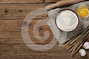 Flour in a bowl with ingredients for preparing baked products