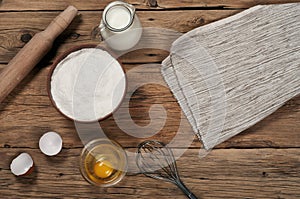 Flour in a bowl with ingredients for preparing baked products