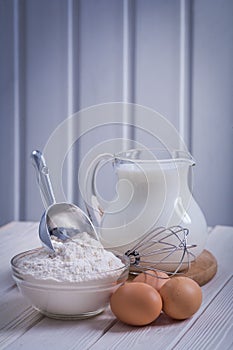 Flour in bowl scoop egs corolla jug with milk on