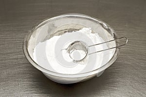 Flour in a bowl. sift. on the table in the kitchen