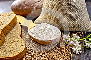 Flour buckwheat in spoon with cereals and bread on board