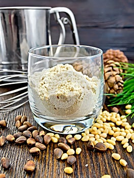 Flour cedar in glass with sieve on board