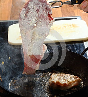 Flour coated beef frying in hot grease