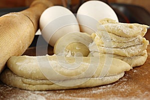 Flour dough with rolling pin and egg