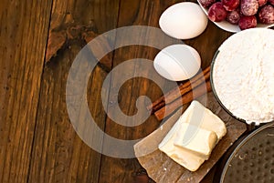 Flour, eggs, cherry oil, cinnamon, on a wooden table