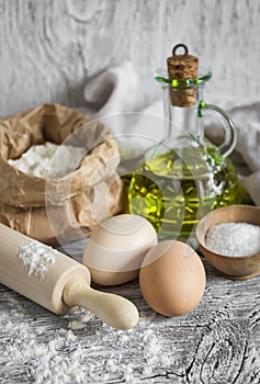 Flour, eggs, olive oil - ingredients to prepare the dough for pasta