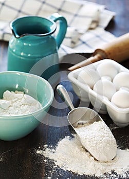 Flour and eggs on a wooden table