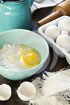 Flour and eggs on a wooden table