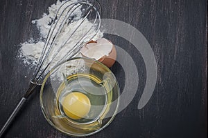 Flour and eggs on a wooden table