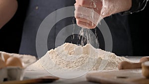 Flour falling from baker`s hand