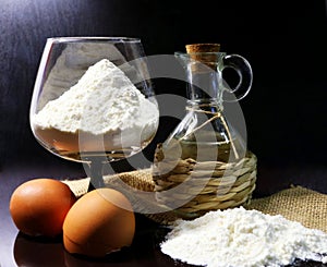 Flour. Food product. The process of preparing the dough. Eggshell. Coconut oil. Flour in a glass. Spilled flour. Oil in a pitcher.