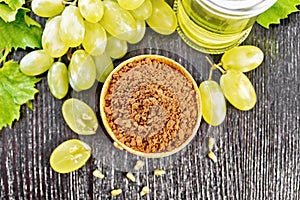 Flour grape seed in bowl on dark board top