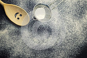 Flour and kitchen utensils on a dark table. Christmas baking. Food background. Winter holiday background. Template