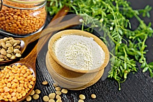 Flour lentil in bowl on dark board