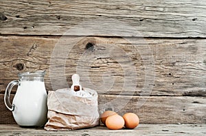 Flour in a paper bag with eggs and milk