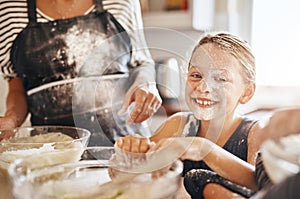 Flour, playing or portrait of girl baking in kitchen with a messy young kid smiling with a dirty face at home. Smile