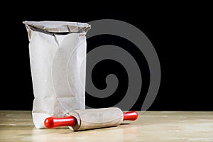 Flour and rolling pin for kneading the dough on the kitchen table. Accessories and kitchen products.