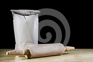 Flour and rolling pin for kneading the dough on the kitchen table. Accessories and kitchen products.