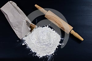 Flour and rolling pin for kneading the dough on the kitchen table. Accessories and kitchen products.