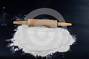 Flour and rolling pin for kneading the dough on the kitchen table. Accessories and kitchen products.