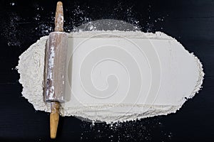 Flour and rolling pin for kneading the dough on the kitchen table. Accessories and kitchen products.