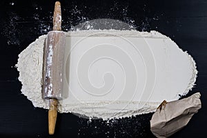 Flour and rolling pin for kneading the dough on the kitchen table. Accessories and kitchen products.