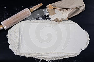 Flour and rolling pin for kneading the dough on the kitchen table. Accessories and kitchen products.