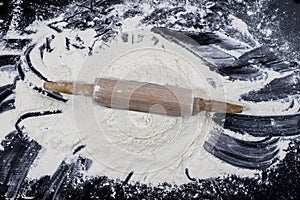 Flour and rolling pin for kneading the dough on the kitchen table. Accessories and kitchen products.