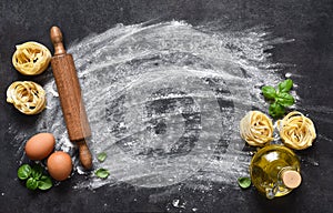 Flour and rolling pin on the table. The process of cooking tagliatelle pasta on the kitchen table